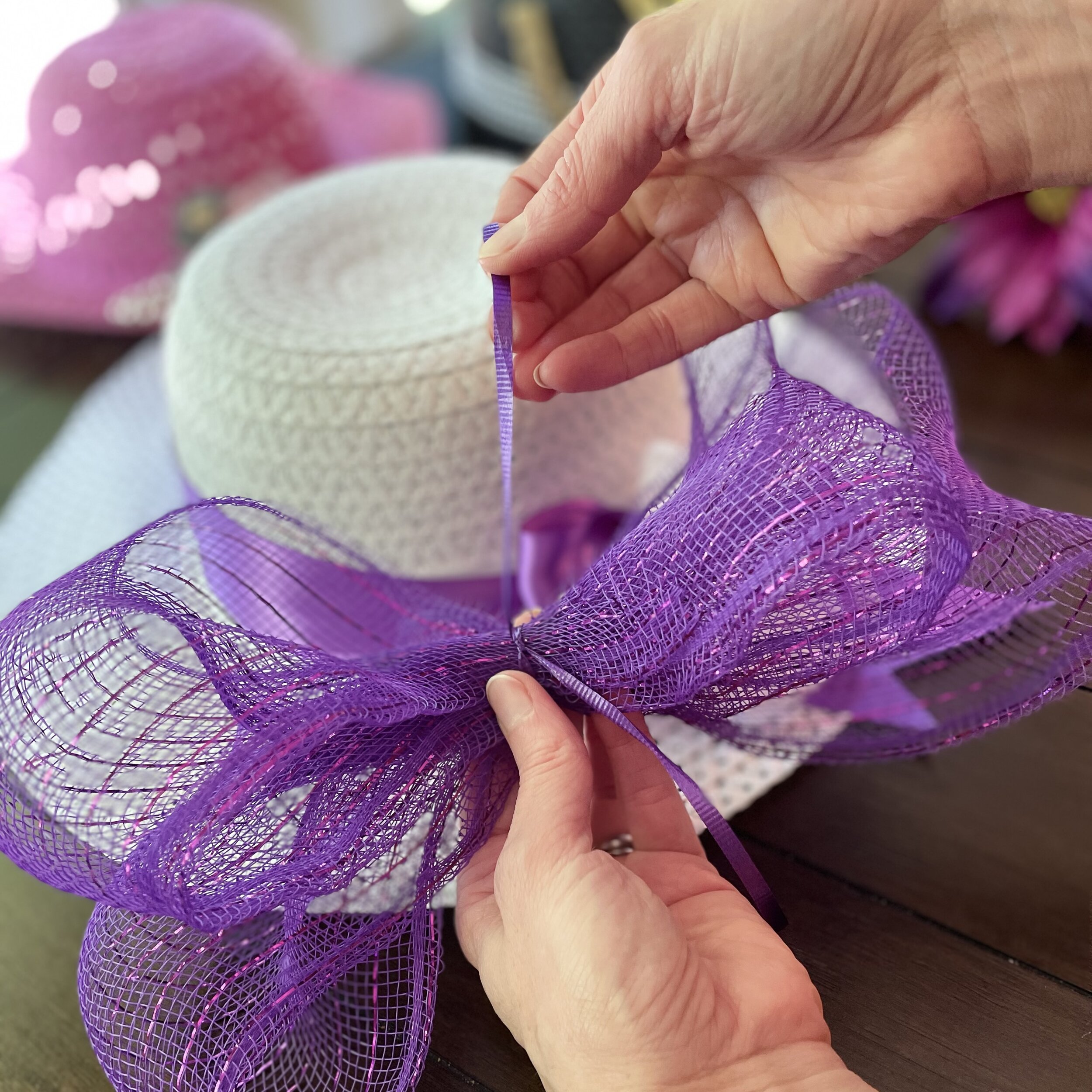 How to add wide mesh purple ribbon to a white diy kentucky derby or easter hat.