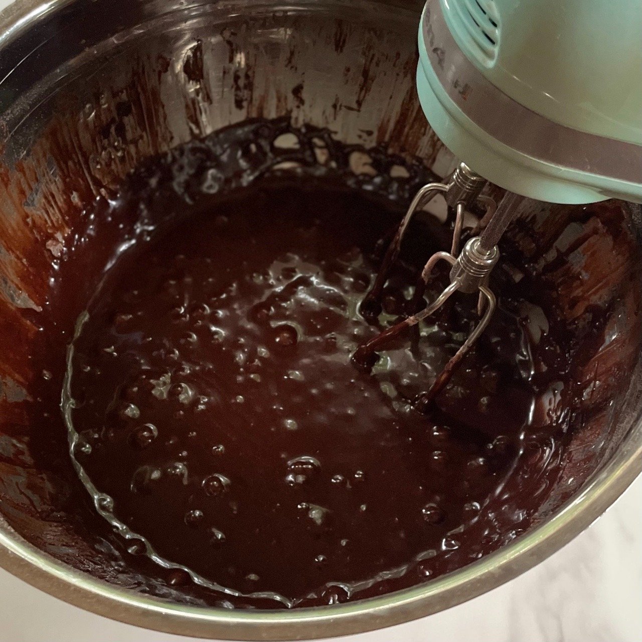 mixing wet ingredients to make dark chocolate cupcakes