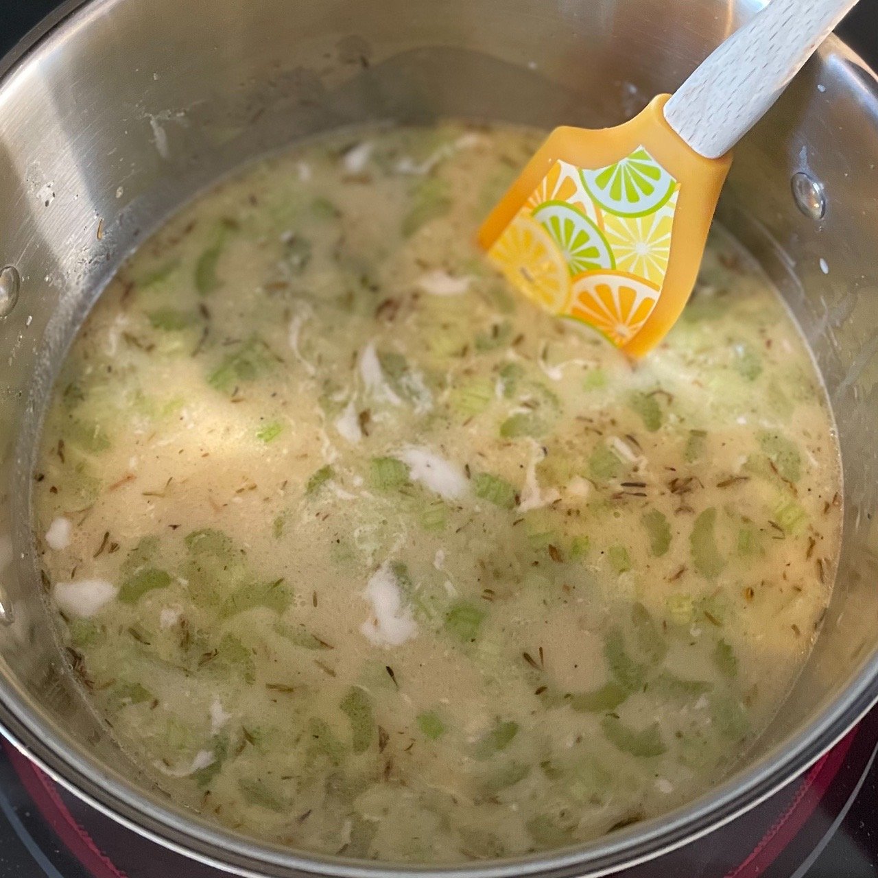 Adding bone broth coconut milk and lemon juice to the base of homemade chicken gnocchi soup.