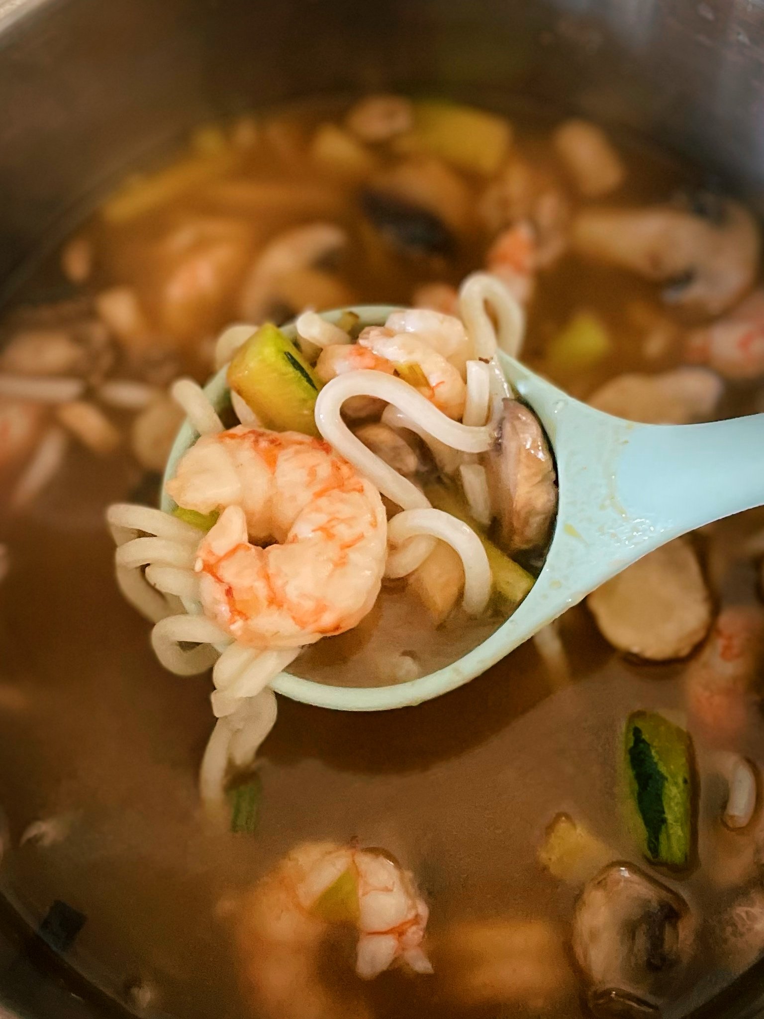 healthy recipe using bone broth for a spicy shrimp udon noodle soup.