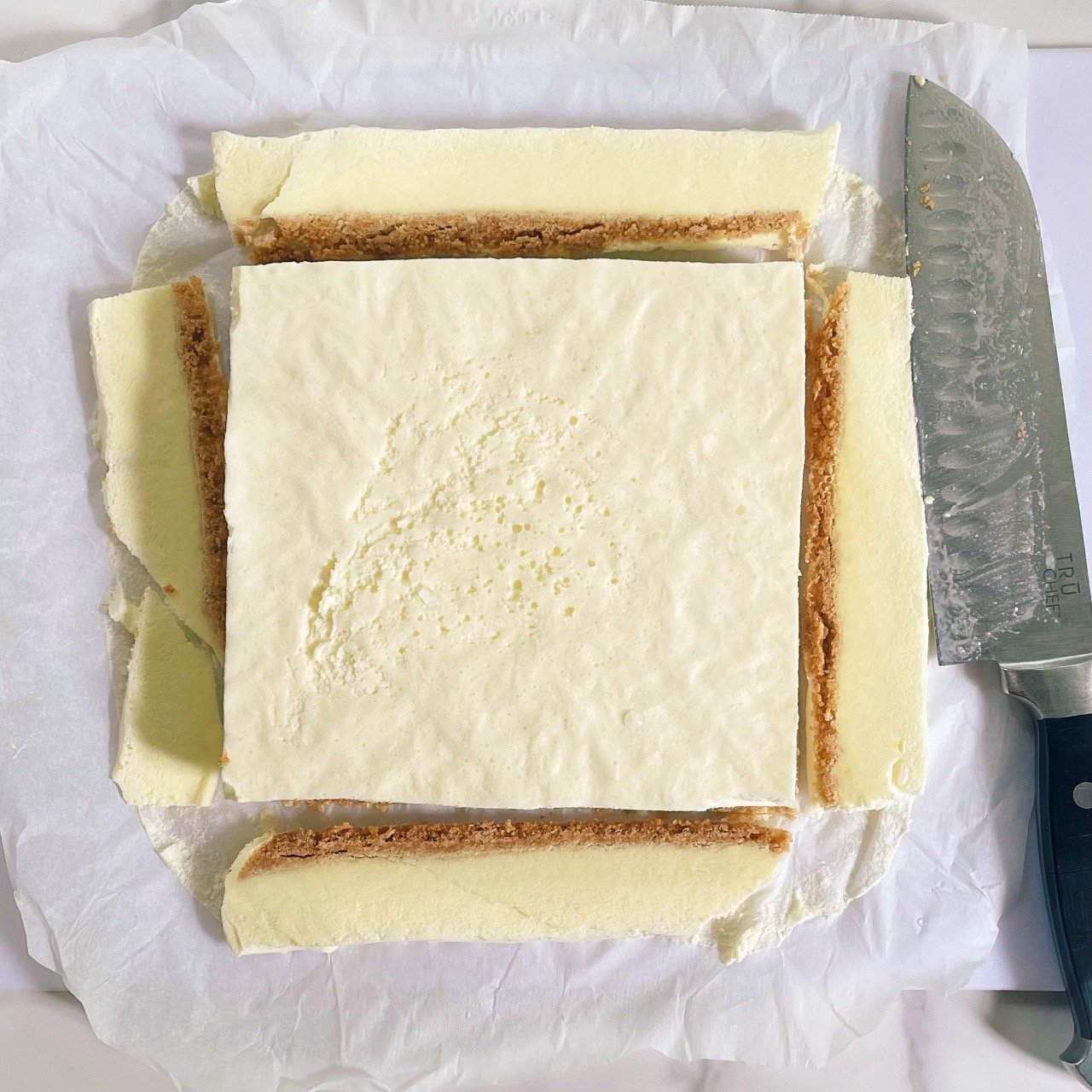 Cutting edges of lemon fluff dessert to even out sides.