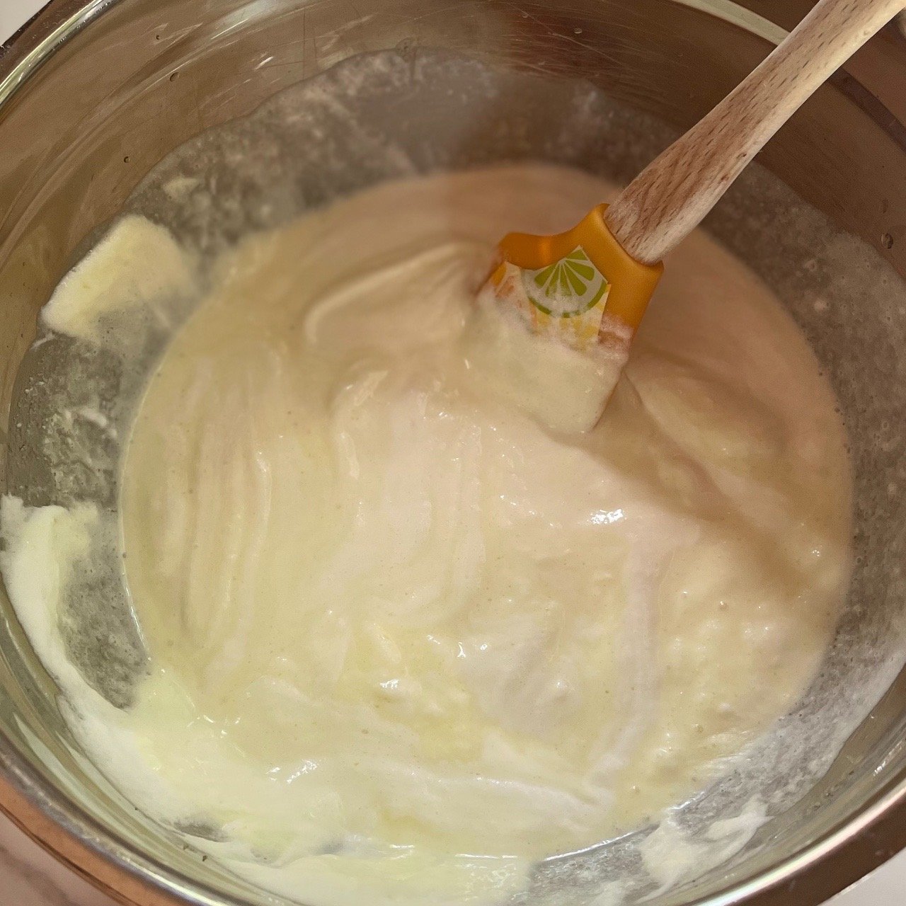 Folding in whipped topping to Jello mixture to make a lemon fluff filling.