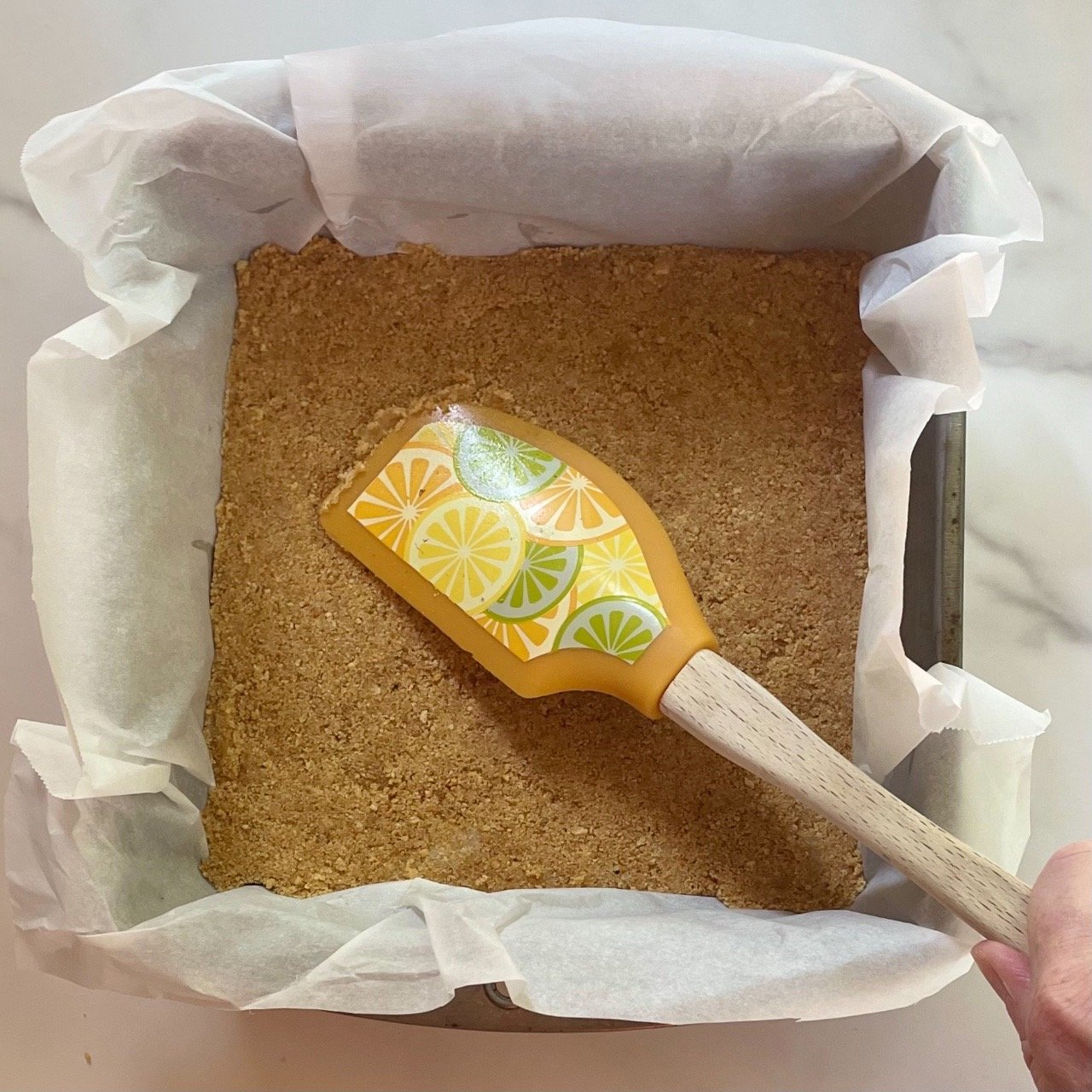 Making a graham cracker crust for lemon fluff dessert.